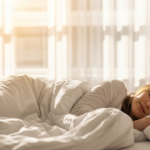 Woman sleeping peacefully in a bright airy bedroom with soft morning light